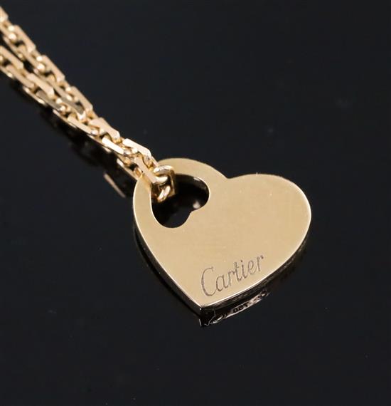A modern 18ct gold Cartier pierced heart shaped pendant, on an 18ct gold Cartier fine link chain, chain 40cm.